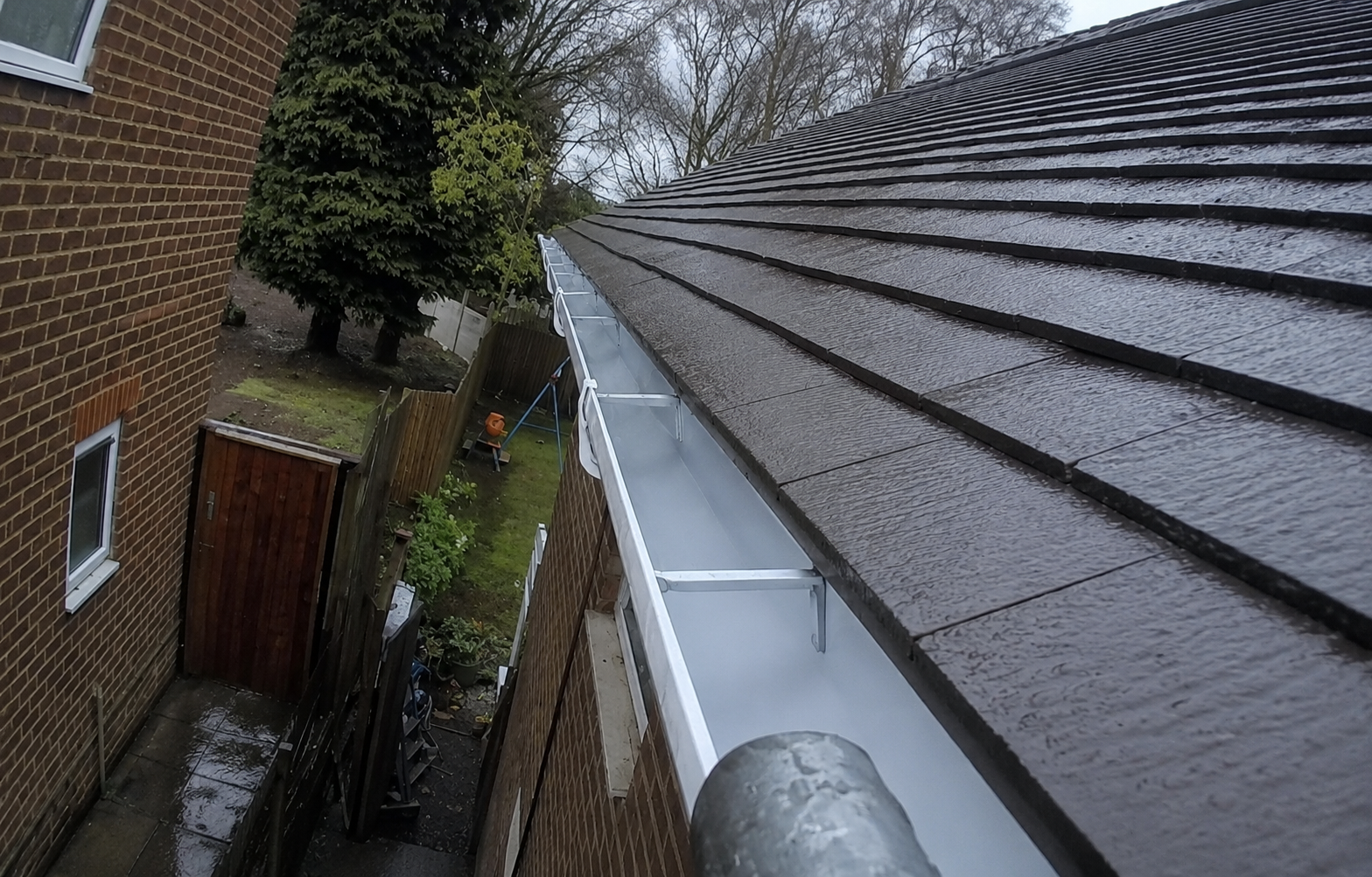 Birmingham gutter after professional cleaning showing clear channel with roofline protection fully restored