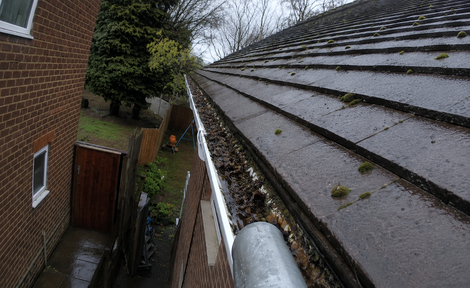 Birmingham gutter before professional cleaning showing compacted debris that silently damages fascia boards and soffits